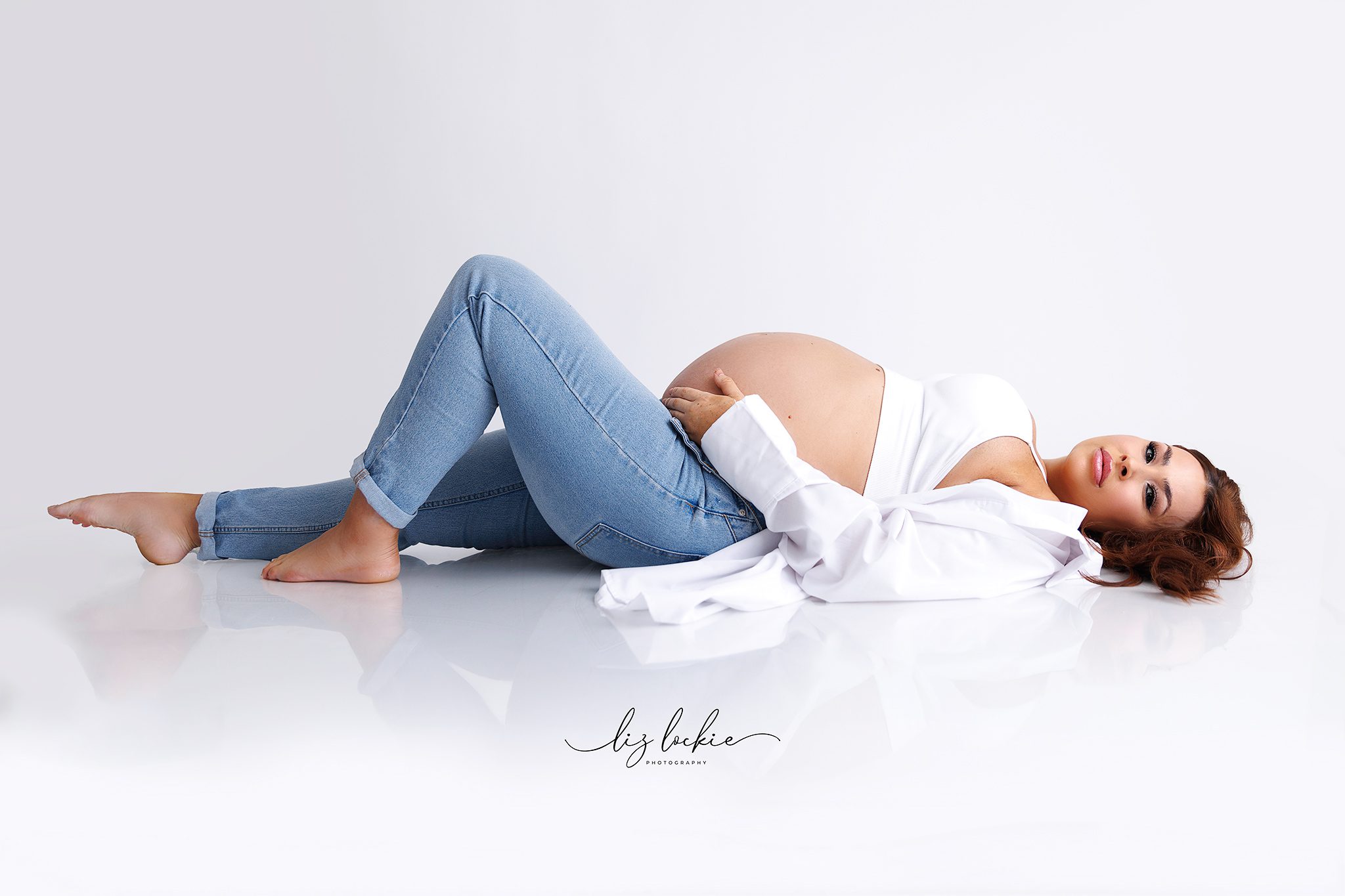 a pregnant woman posing for her maternity session in Woking town centre, Surrey